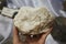 A hand holding raw barite or barytes mineral stone. Barite is the main ore of the element barium.