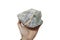 A hand is holding a raw of fluorite rock stone isolated on white background.