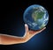 Hand holding realistic globe facing North America