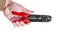 Hand holding red and black equipment plastic and metal cutter