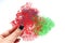 Hand holding red coral lace crepe decorative elements for food plating