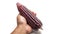 Hand holding a ripe purple corn on isolated white background