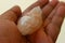 Hand holding rock salt crystal