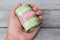 Hand holding a roll of green bank notes