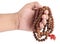 A hand holding a rudraksh bead garland