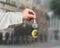 Hand holding silver key with golden euro sign shape keyring, 3D