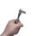 Hand holding small socket wrench or ratchet on white backdrop. Automotive industry.