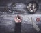 Hand holding small stones in energy healing meditation on rustic wooden table with burning incense and Tibetan prayer bells