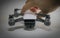 Hand holding small white advanced quadcopter