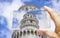 Hand holding a smartphone with the famous Leaning Tower Italy - Pisa - 3D render concept image