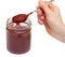 Hand holding a spoonful of homemade ketchup isolated