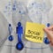 Hand holding sticky note human social network on crumpled pape