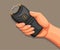 Hand holding taser or stun gun. weapon equipment for self defense concept in cartoon illustration vector