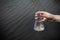 hand holding test tube for analyses with water on the background of the reservoir, the concept of water purity, pollution of water