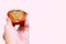 Hand holding Thai ancient eggs cupcake was eaten isolate on pink background