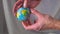 The hand is holding and throwing up the globe. The world is in your hands. Slow motion