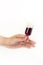 HAND HOLDING A TINY GLASS OF WINE