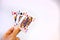 Hand holding a trio of queen cards of poker over a white background