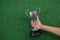 Hand holding a trophy on artificial grass