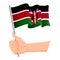 Hand holding and waving the national flag of Kenya. Fans, independence day, patriotic concept. Vector illustration