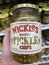 Hand holding wickles pickle chips in a jar