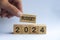 Hand holding wooden block with text - Budget 2024 with blurred nature background. Yearly budget concept