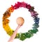 Hand holding wooden bowl over the colorful autumnal circle made of leaves.