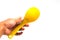 Hand holding yellow plastic Rice spoon on white background