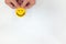 Hand holding a yellow smiley face on a white background. Happy customer, positive feedback and good service concepts