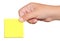 Hand holding a yellow sticker post-it note