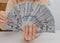 Hand holds american dollars spread out fan