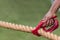 Hand Holds Bandana On Rope Before Tug Of War Contest