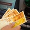 Hand holds banknotes of 100 new Israeli shekels behind the Cash Machine