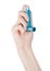 Hand holds blue asthma inhaler for relief asthma