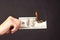 Hand holds burning dollar isolated on a black background.