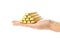 The hand holds chocolate bars in the shape of gold bars. Close up. Isolated on a white background