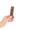 Hand holds chocolate stick.