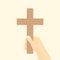 Hand holds christian cross