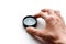 The hand holds a compass. Closeup. Isolated on a white background