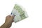 Hand holds euro currency in a fan. A pack of money in denominations of 100 euros. Isolated