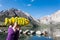 Hand holds a fish shaped decorated sugar cookie in front of Convict Lake, a popular fishing destination in California