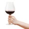 Hand holds goblet glass with red wine