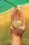 The hand holds a heart made of natural stone yellow jadeite. Heart in hand. A stone in the shape of a heart. Love