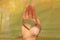 The hand holds a heart made of natural stone yellow jadeite. Heart in hand. A stone in the shape of a heart. Love talisman, zen,