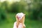 The hand holds a juicy, appetizing ice cream on the background of a natural background. Bright sunny day