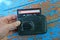 Hand holds old black audio player with cassette