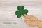 Hand holds ornate clover four-leaf. Celebration concept St. Patr