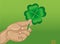 Hand holds ornate clover tree-leaf. Celebration concept Patrick