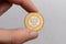 A hand holds a Polish two zloty coin on a white background close-up