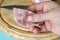 Hand holds real Homemade chopped ham with garlic, salt and black